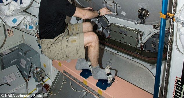 Astronaut wearing socks in space capsule