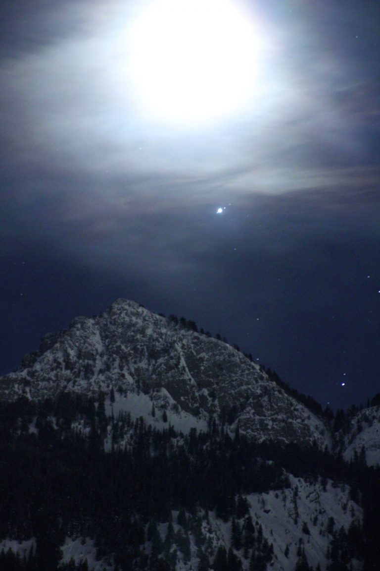 As the Moon rose over the Wasatch Mountains near Salt Lake City on Feb. 27, 2019, the planet Jupiter could be seen, along with three of its largest moons. Stargazers should have a similar view during Jupiter in Opposition on Monday, Sept. 26. Credits: NASA/Bill Dunford
